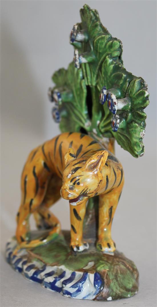 An early 19th century Staffordshire pearlware figure of an arched tiger, 13.5cm, damages